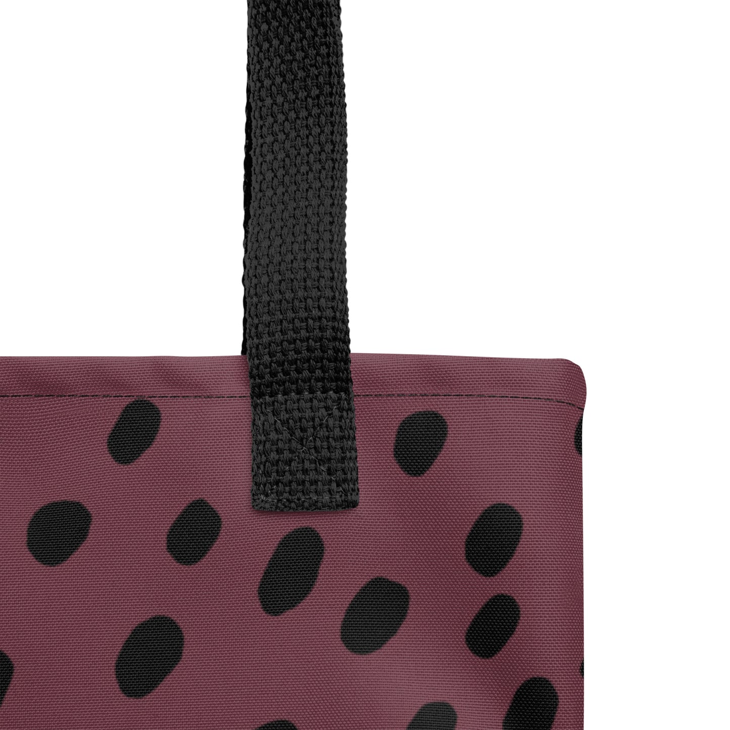 Close-up of TASHAU tote showing fabric texture and bold black dot accents on a white background.