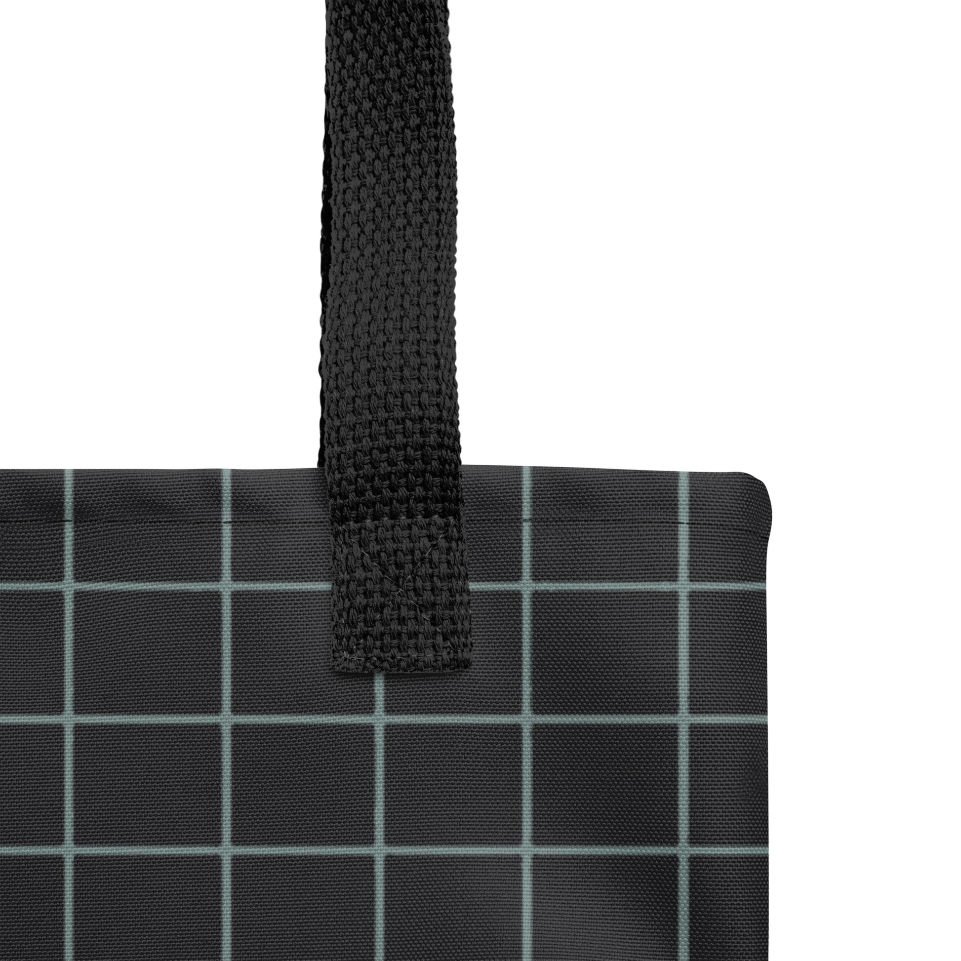 Black grid-patterned bag with a black strap on a white background by TASHAU.