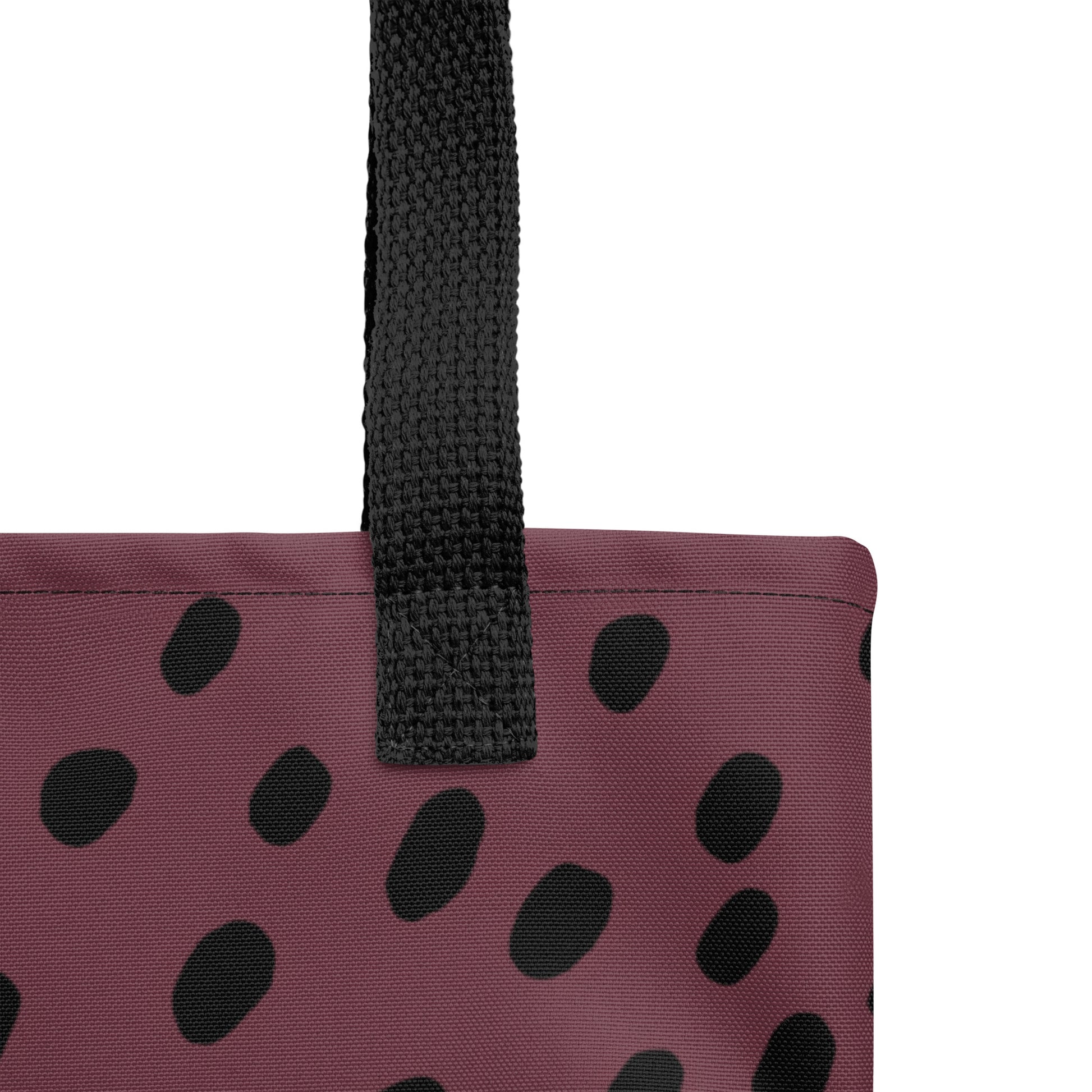 Close-up of TASHAU tote showing fabric texture and bold black dot accents on a white background.