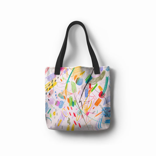 Front view of TASHAU Joyful Jumble tote bag with multicolor abstract pattern.