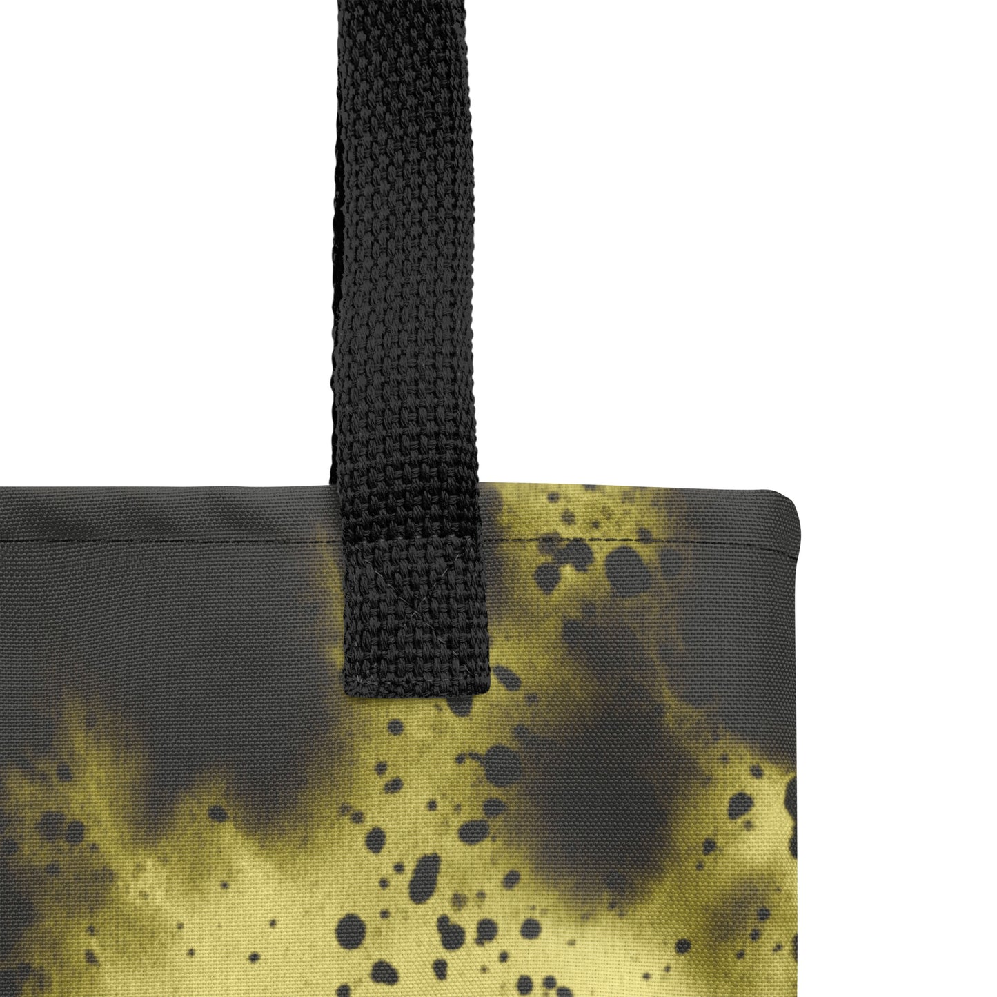 Close-up of a designer canvas tote for everyday use in black with glowing golden-yellow accents.