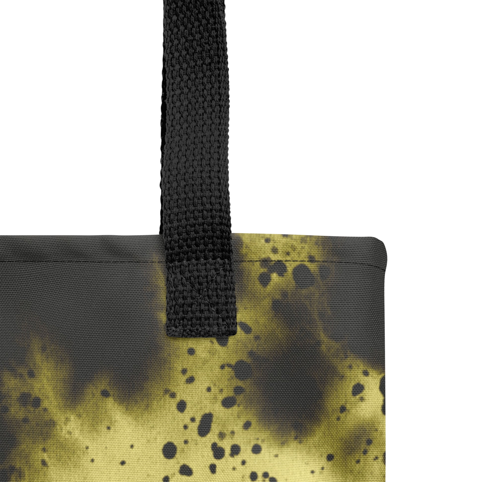 Close-up of a designer canvas tote for everyday use in black with glowing golden-yellow accents.