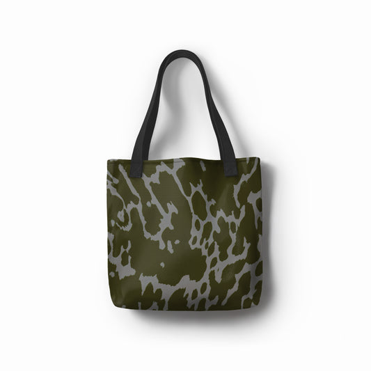 Front view of TASHAU Urban Mirage tote bag in olive green and gray abstract camouflage print.