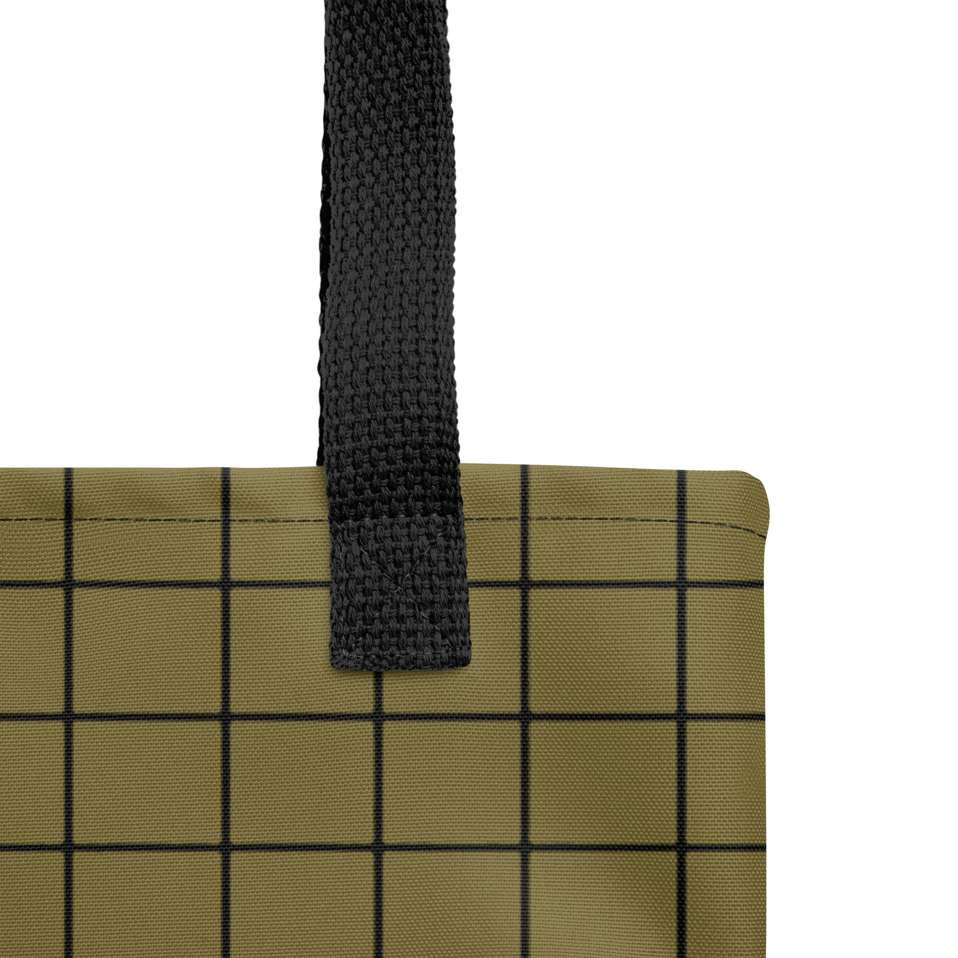 Close-up of a green grid-patterned bag with a black handles on a white background  by TASHAU.
