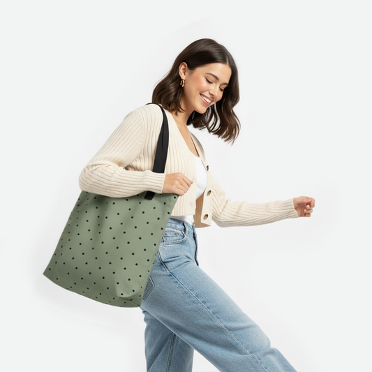 Woman carrying olive green tote bag with black polka dots by TASHAU.