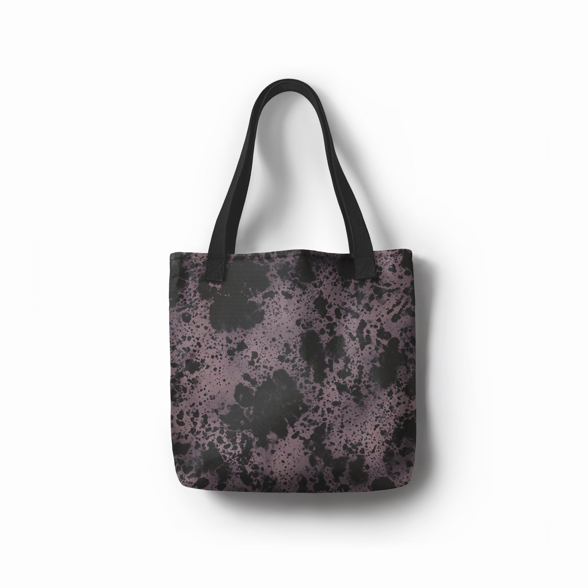 Front view of artistic tote bag in charcoal black and dusty purple abstract stone texture. Designed by TASHAU.