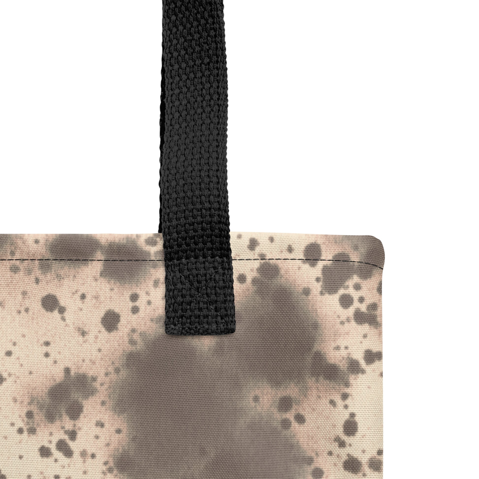 Close-up of tote bag showing artistic abstract brown and beige print on durable canvas fabric. TASHAU
