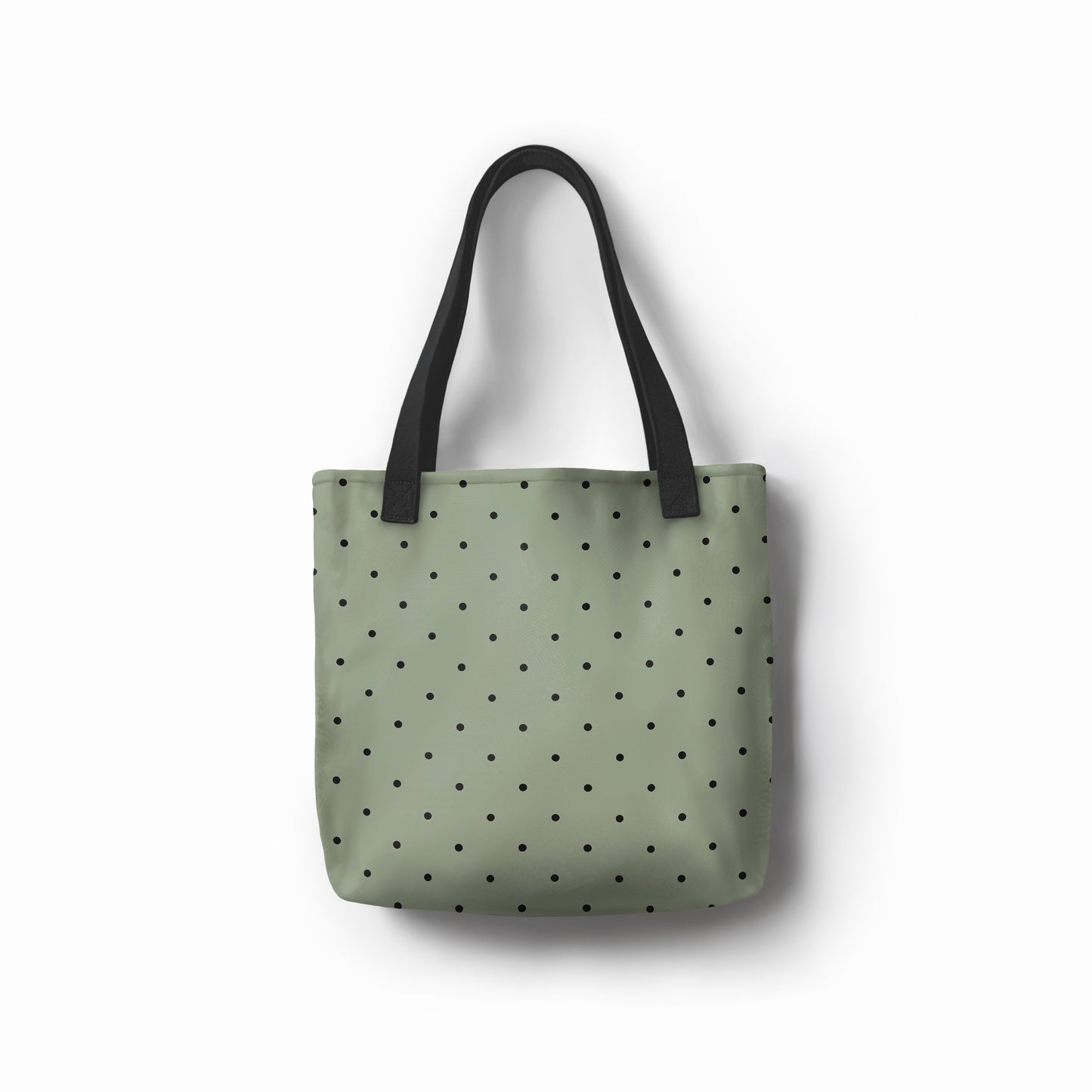 Unisex shopper bag in sage green with modern black dot pattern.