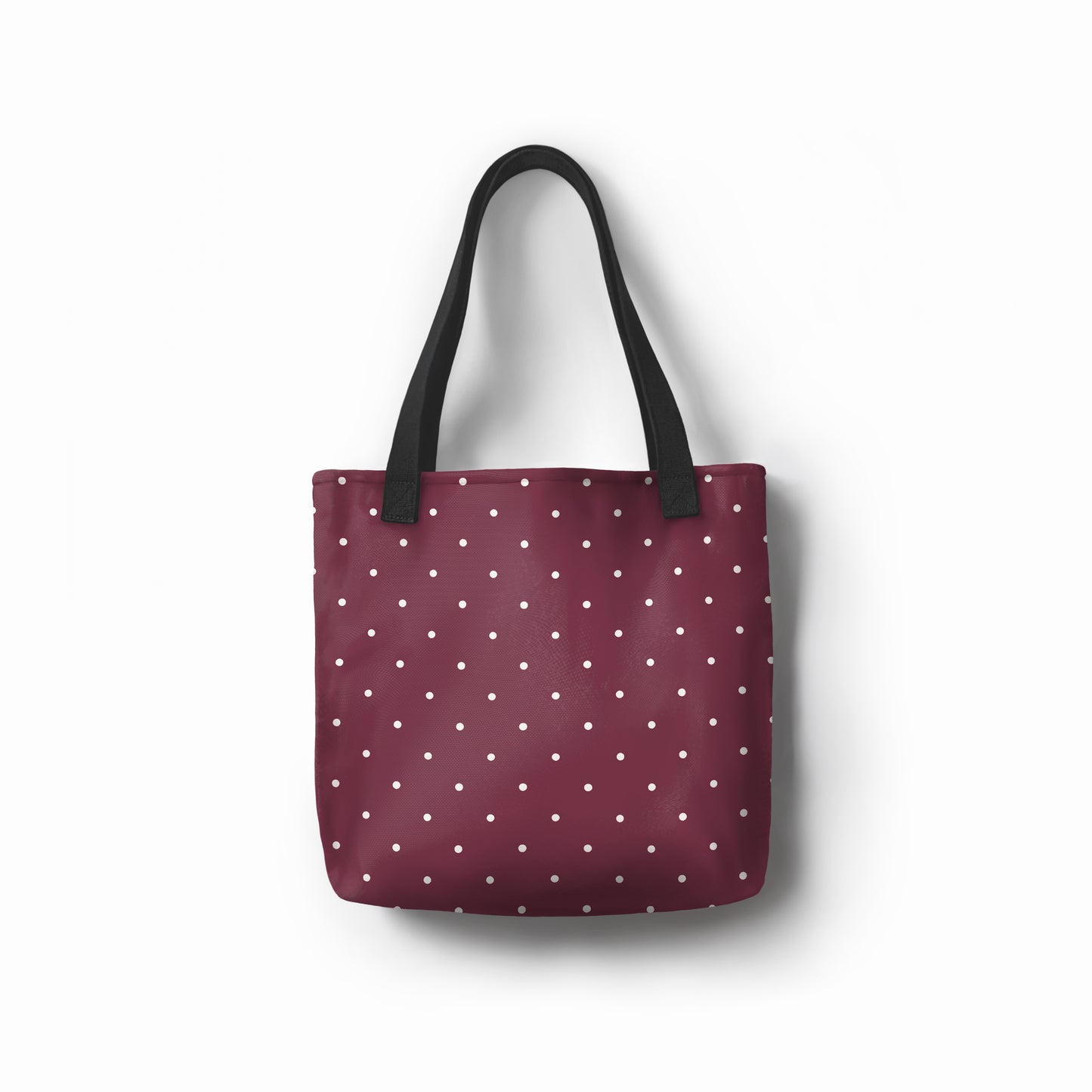 Burgundy dots tote bag with wine red base and white polka dot pattern.
