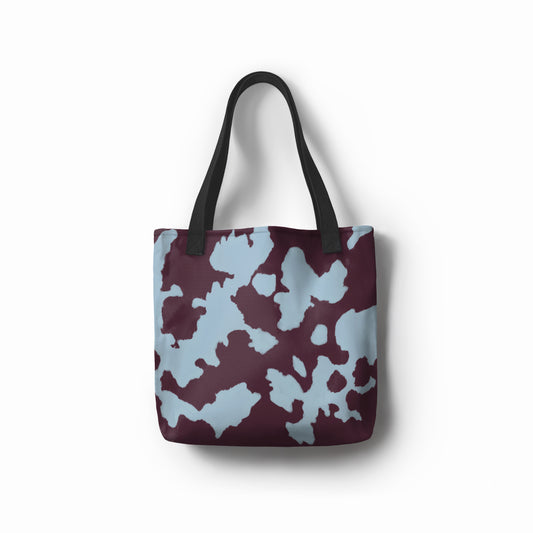 TASHAU Cenote Depths tote bag in maroon with blue abstract water-inspired patterns.