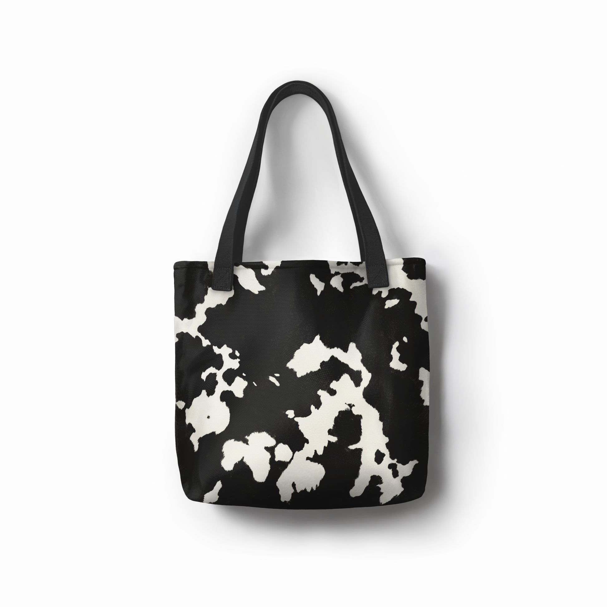 Stylish monochrome tote shopper bag for women with bold cow print design.