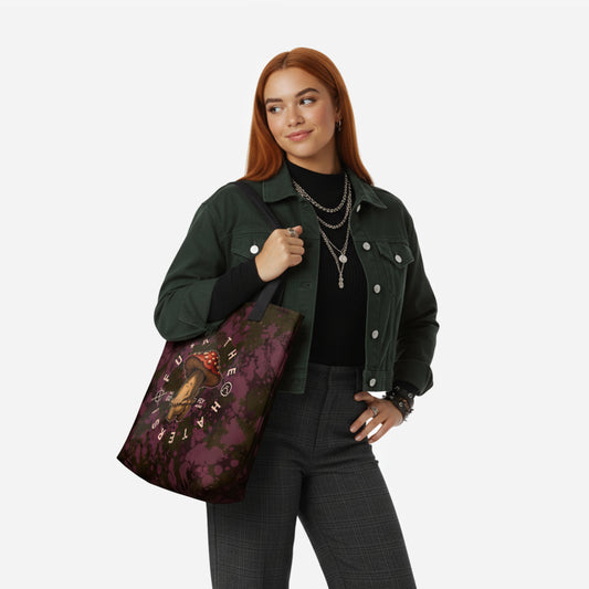 Woman holding a burgundy tote bag with a mushroom rebel sarcastic design.